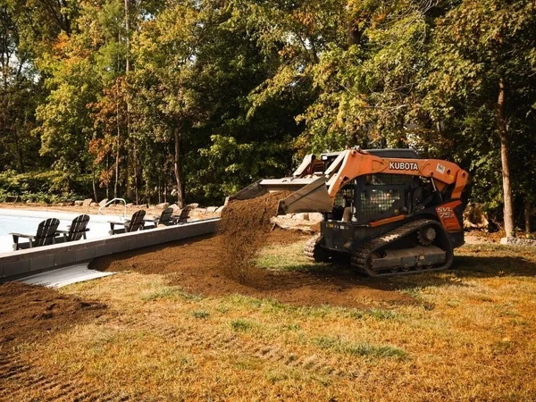 MAC Excavation & Landscape crew operating equipment on a residential property in South Shore MA