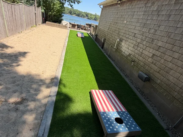 Turf Game Lane & Bocce Court — Plymouth, MA Artificial turf game lane and bocce court installation alongside a home in Plymouth, MA